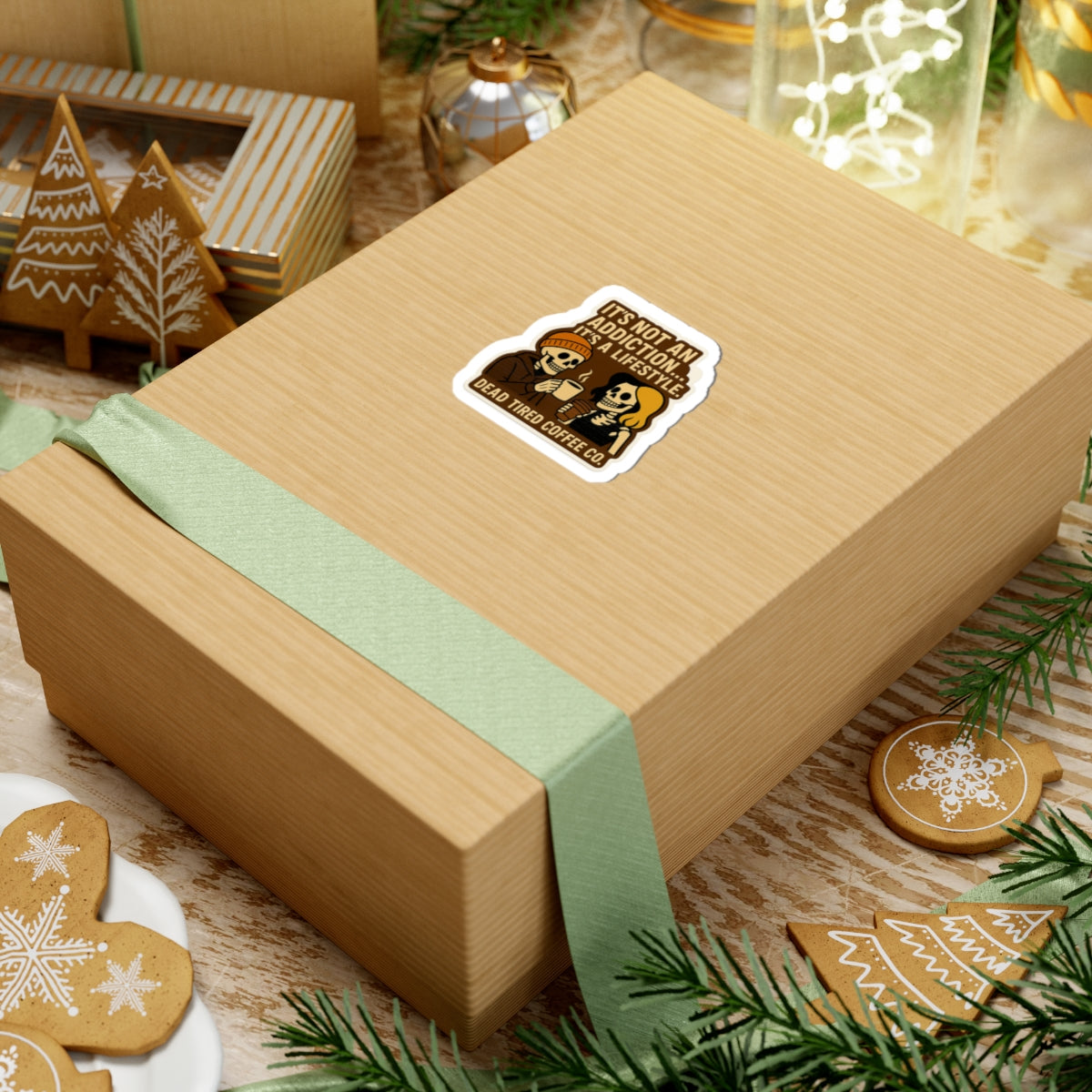 Gift box with a decorative label on a festive background with cookies and greenery