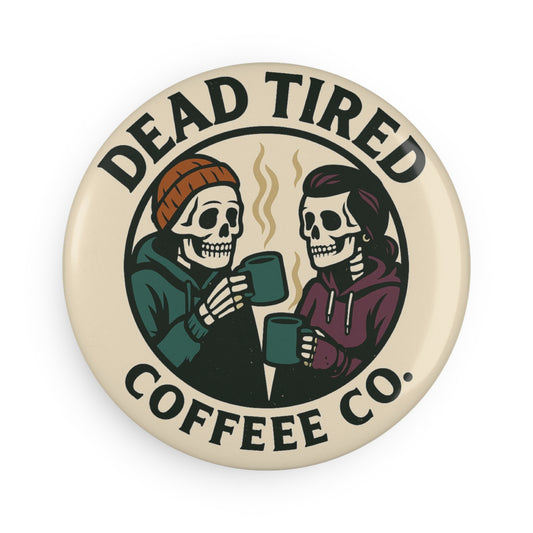 Button badge with skeletons drinking coffee and 'Dead Tired Coffee Co.' text on a beige background