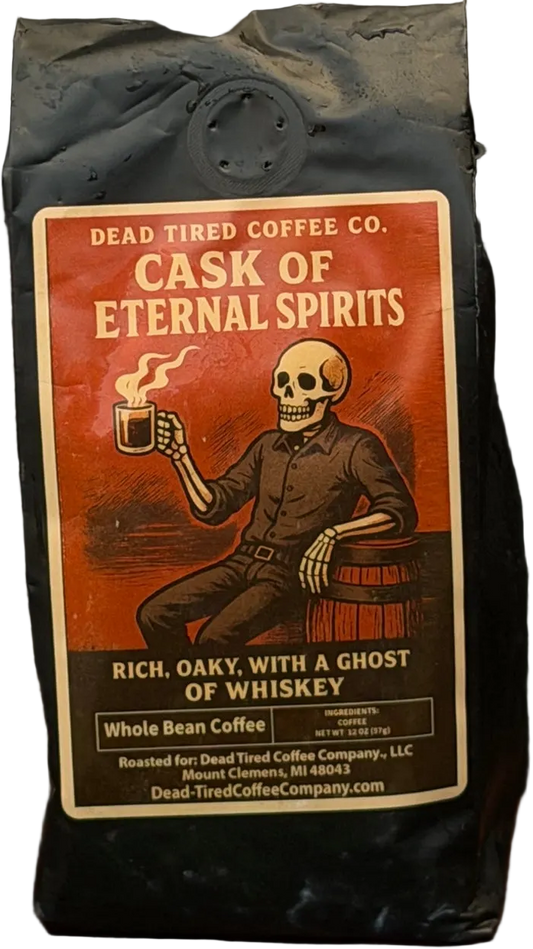 Cask of Eternal Spirits coffee bag by Dead Tired Coffee Co. The rust-red label shows a skeleton raising a steaming mug beside a barrel, a nod to its whiskey barrel-aged Guatemala coffee.
