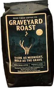 Graveyard Roast coffee bag by Dead Tired Coffee Co. Its midnight graveyard label shows a skeletal hand lifting a steaming mug beneath the moon; inside is a specialty-grade six-bean dark roast.