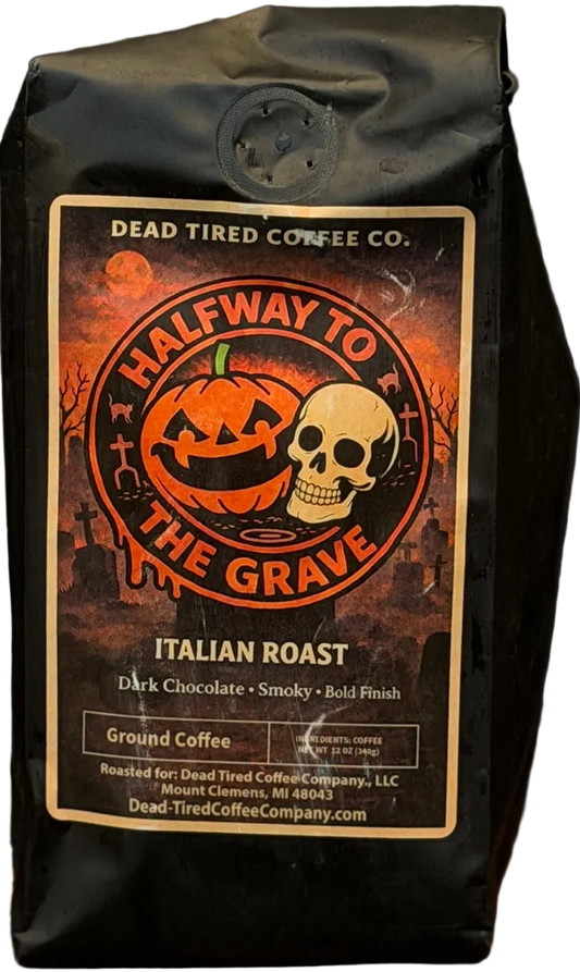 Halfway to the Grave Italian dark roast coffee bag by Dead Tired Coffee Co. A grinning jack-o'-lantern and skull sit in a graveyard on the Halloween label of this bold coffee.
