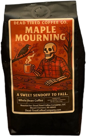 Maple Mourning maple pecan coffee bag by Dead Tired Coffee Co. The autumn label shows a plaid-shirted skeleton with a steaming mug, a crow, and falling leaves.