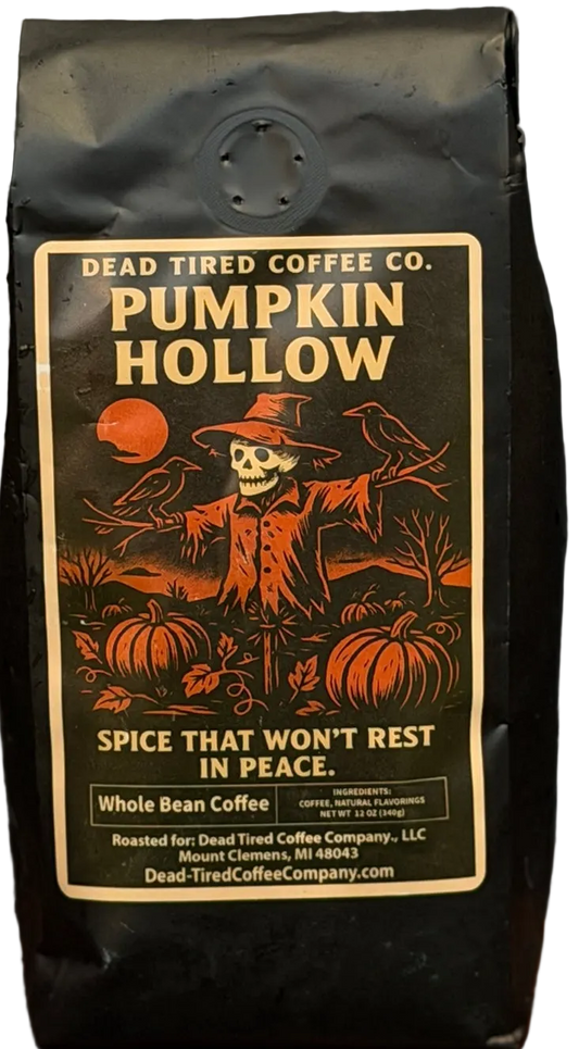 Pumpkin Hollow pumpkin spice coffee bag by Dead Tired Coffee Co. Its spooky harvest label shows a skeleton scarecrow among pumpkins and crows under an orange moon.