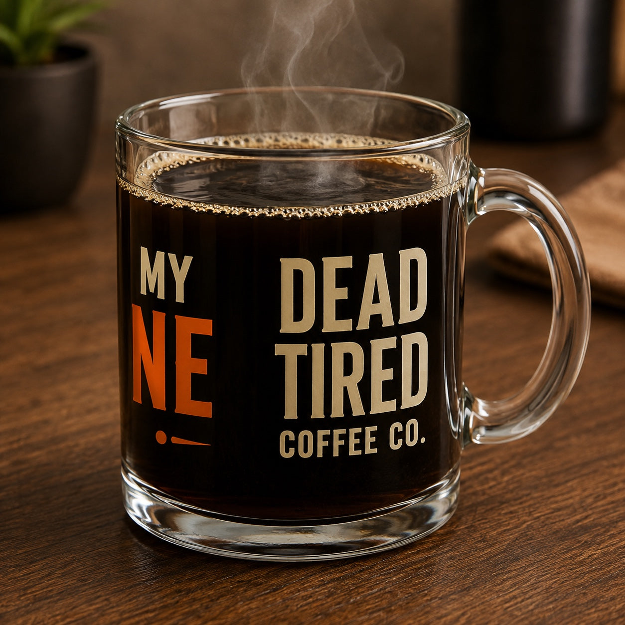 Dead Tired Coffee Co. side of clear glass coffee mug with handle on right