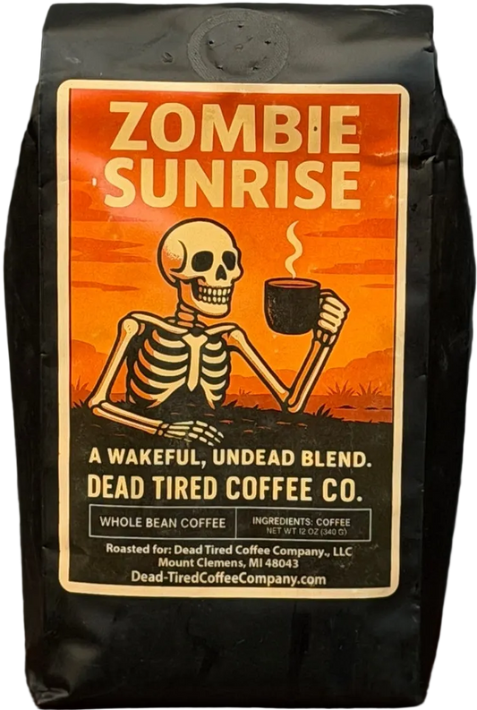 Zombie Sunrise breakfast blend coffee bag by Dead Tired Coffee Co. The orange sunrise label shows a skeleton rising with a steaming mug; inside is specialty-grade medium-light coffee roasted to order.